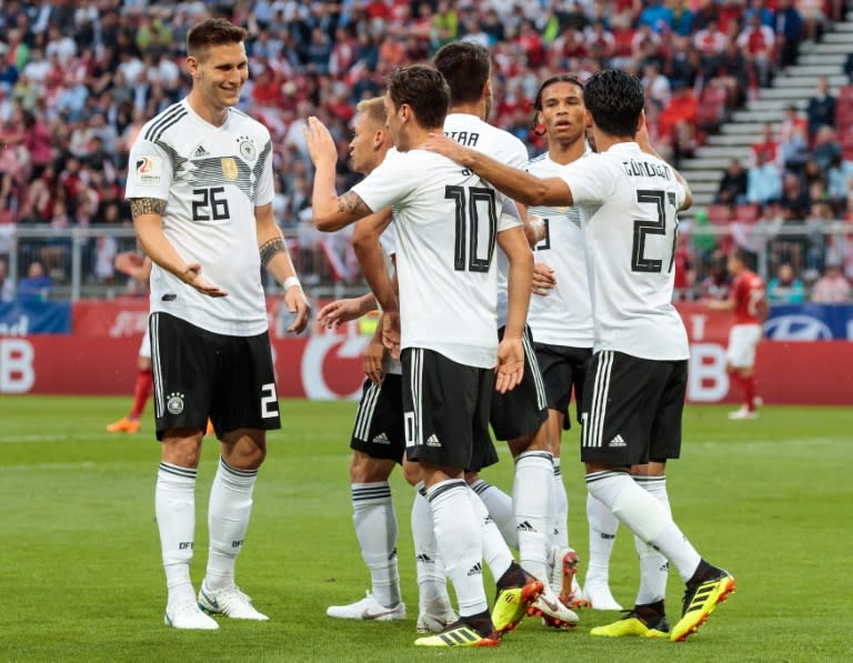 Germany's midfielder Mesut Ozil (C) celebrates scoring the opening goal in the Austria v Germany friendly on June 2, but was booed by travelling German fans in Klagenfurt, Austria