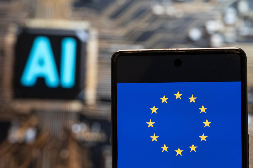 In this photo illustration, the European Union (EU) logo and flag seen displayed on a smartphone with an Artificial intelligence (AI) chip and symbol in the background. (Photo by Budrul Chukrut / SOPA Images/Sipa USA) *** Strictly for editorial news purposes only ***(Sipa via AP Images)