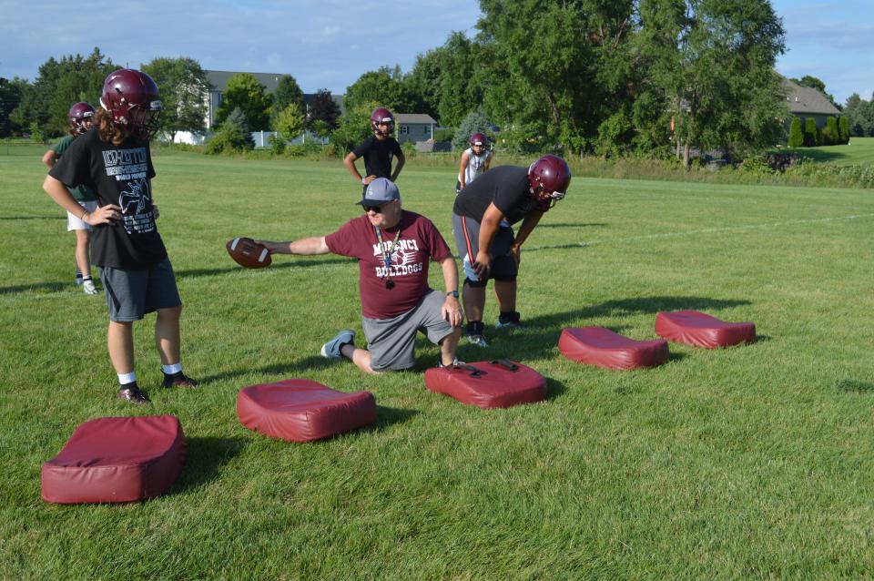 Morenci assistant coach, hall of famer Alan Boydston, directs Brady Pummel (left) and Emmanuel Depalma during a drill at a Morenci practice.