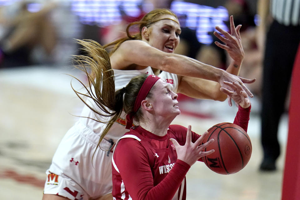 Wisconsin forward Tara Stauffacher, front, and Maryland forward Chloe Bibby compete for a rebound during the first half of an NCAA college basketball game, Thursday, Feb. 4, 2021, in College Park, Md. (AP Photo/Julio Cortez)