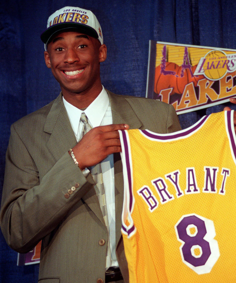 Kobe Bryant, 17, holds his Los Angeles Lakers jersey during a news conference, on July 12, 1996. | Susan Sterner—AP