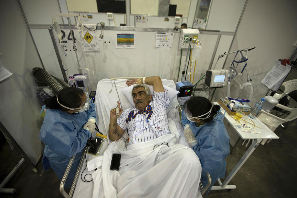 COVID-19 patient Leon Faure talks with psychologists in a field hospital built inside the Citibanamex convention center in Mexico City. Source: AAP 