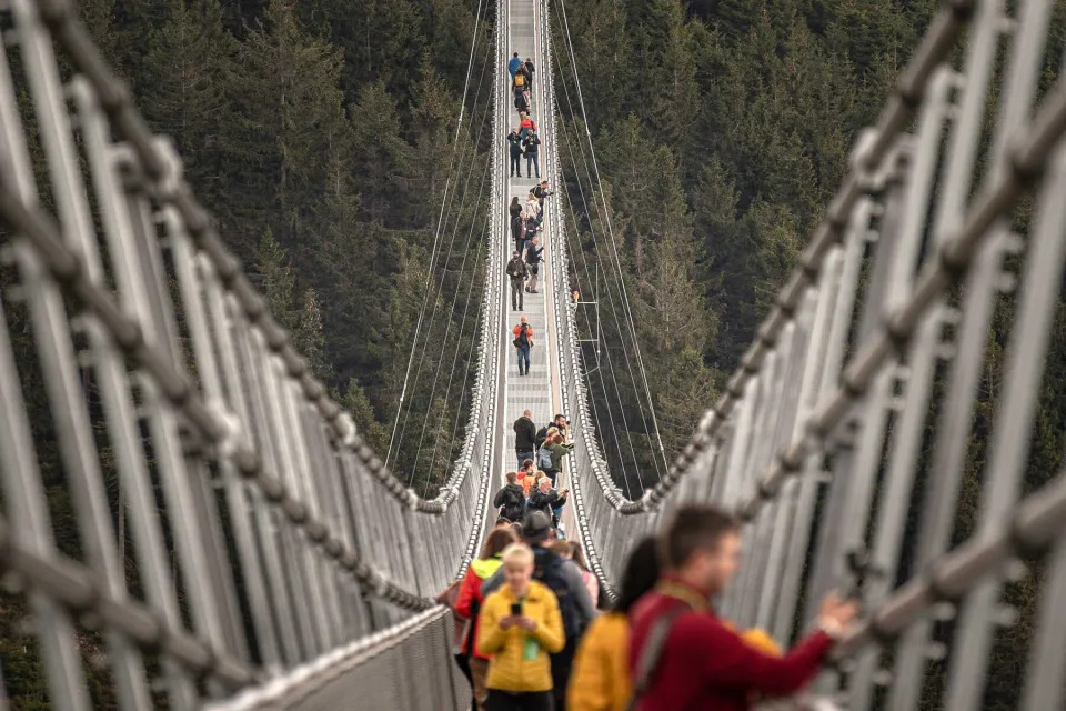 9: Visitors walk on the Sky Bridge 721, the world&#39;s longest suspension pedestrian bridge in Dolni Morava, Czech Republic on May 9, 2022. Sky Bridge 721, the longest pedestrian bridge in the world with a length of 721 meters and an elevation of 95 meters above the ground, is located in the Pardubice region (a break between the Eagle Mountains and the Jesenice).