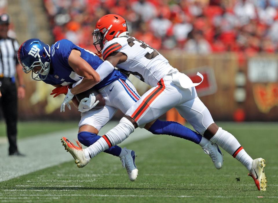 Cleveland Browns cornerback A.J. Green (38) tackles New York Giants wide receiver David Sills (84) out of bounds during the first half of an NFL preseason football game, Sunday, Aug. 22, 2021, in Cleveland, Ohio. [Jeff Lange/Beacon Journal]