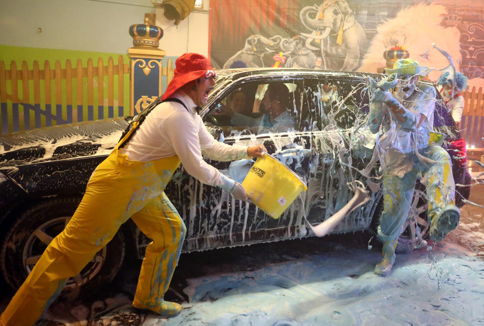 Clowns of the circus Krone joke around in the circus own car wash to bring joy to the people during the playing ban due to the coronavirus disease (COVID-19), in Munich, Germany, August 20, 2020. REUTERS/Michael Dalder