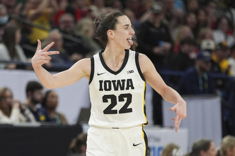 Iowa guard Caitlin Clark (22) celebrates after making a 3-point basket during the first half of an NCAA college basketball game against Michigan in the semifinals of the Big Ten women's tournament Saturday, March 9, 2024, in Minneapolis. (AP Photo/Abbie Parr)