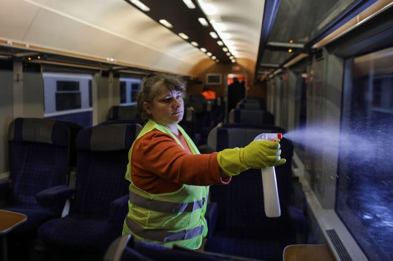 Cleaning staff uses disinfectants to clean a train of the Romanian Railway Service