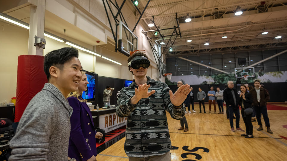 As part of the Immersive Basketball Experience launched by MLSE and AWS's SpaceX initiative, reporters test out virtual reality capabilities on the practice court at Scotiabank Arena. Viewers can see life-size 3D renderings of him in sports games.  (Credit: MLSE)