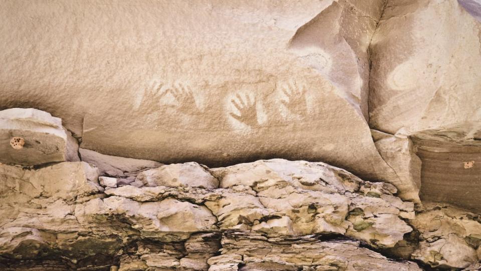 <div class="inline-image__caption"><p>Anasazi handprints above Deer Creek Falls.</p></div> <div class="inline-image__credit">David Madison/Getty</div>