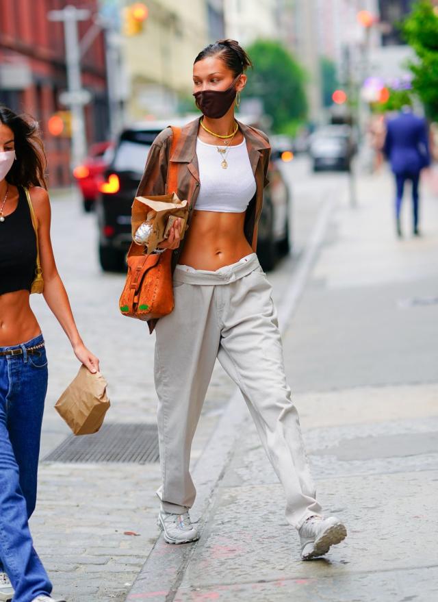 Bella Hadid in Red Tracksuit Carrying a Louis Vuitton Backpack