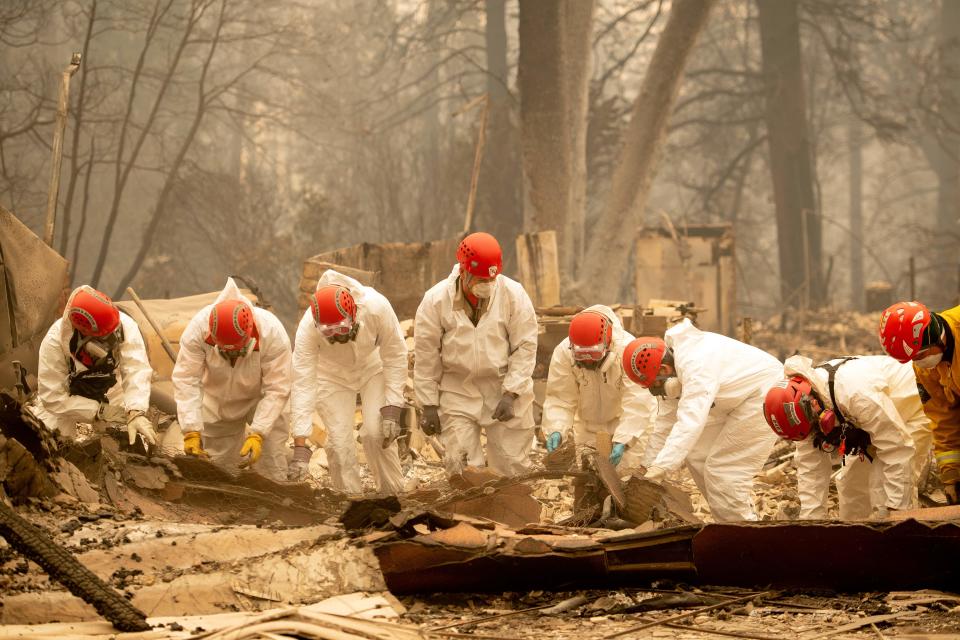 Rescue workers sift through the remains of a building in Paradise, California (AFP/Getty)