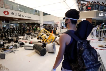 Anti-government protesters pile up projectiles to block police from entering New Town Plaza at Sha Tin