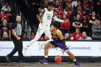 East Carolina's Jayden Gardner (1) looks to pass around Cincinnati's Tre Scott (13) during the first half of an NCAA college basketball game, Sunday, Jan. 19, 2020, in Cincinnati. (AP Photo/John Minchillo)