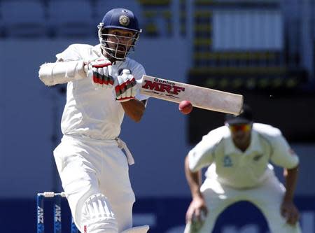 Shikhar Dhawan plays a pull shot while scoring a century during his second innings on day four of the first international test cricket match against New Zealand at Eden Park in Auckland, February 9, 2014. REUTERS/Nigel Marple