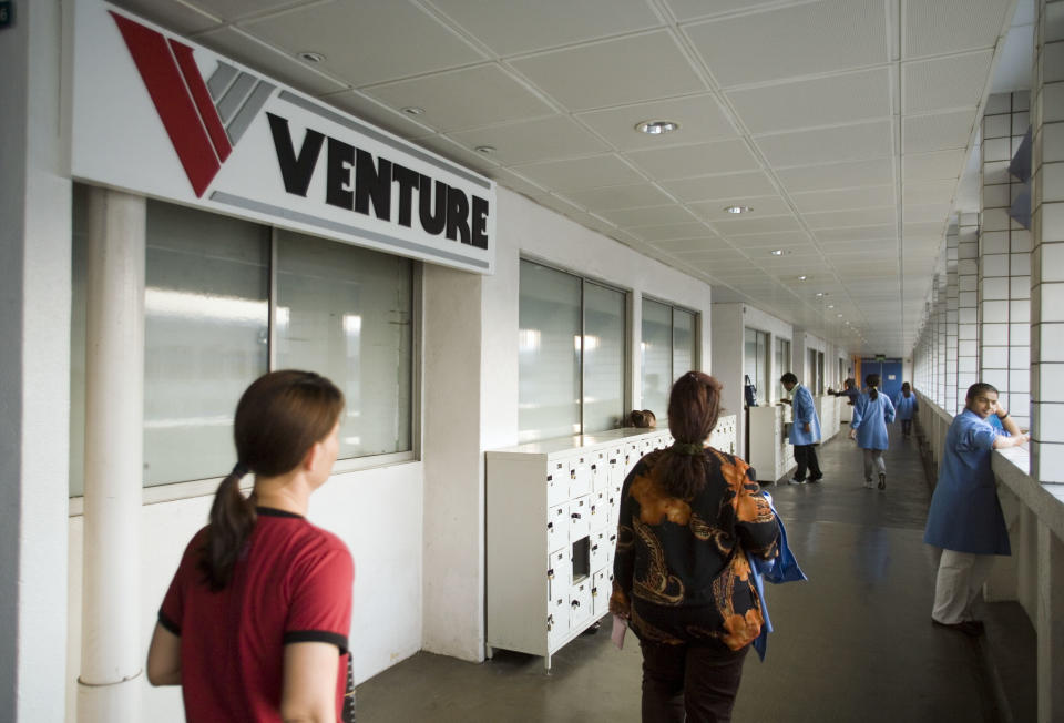 Employees walking down a corridor at a Venture Corp facility in Singapore. (File photo: Getty Images)