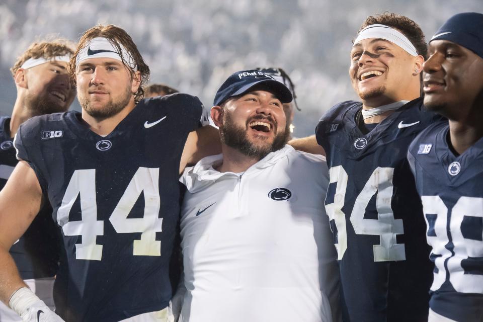 Penn State co-offensive coordinator/tight ends coach Ty Howle (center) puts his arms around tight ends Tyler Warren (44) and Theo Johnson (84) following a 31-0 White Out win against Iowa Saturday, Sept. 23, 2023, in State College, Pa.