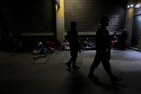 Soldiers patrol as Hondurans wait to leave with a new caravan of migrants, set to head to the United States, at a bus station in San Pedro Sula, Honduras January 14, 2019. REUTERS/Jorge Cabrera