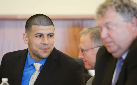 Former NFL New England Patriots football player Aaron Hernandez talks with his defense attorney, Charles Rankin (C) during a hearing at the Bristol County Superior Court House in Fall River, Massachusetts, June 16, 2014. REUTERS/Faith Ninivaggi/POOL