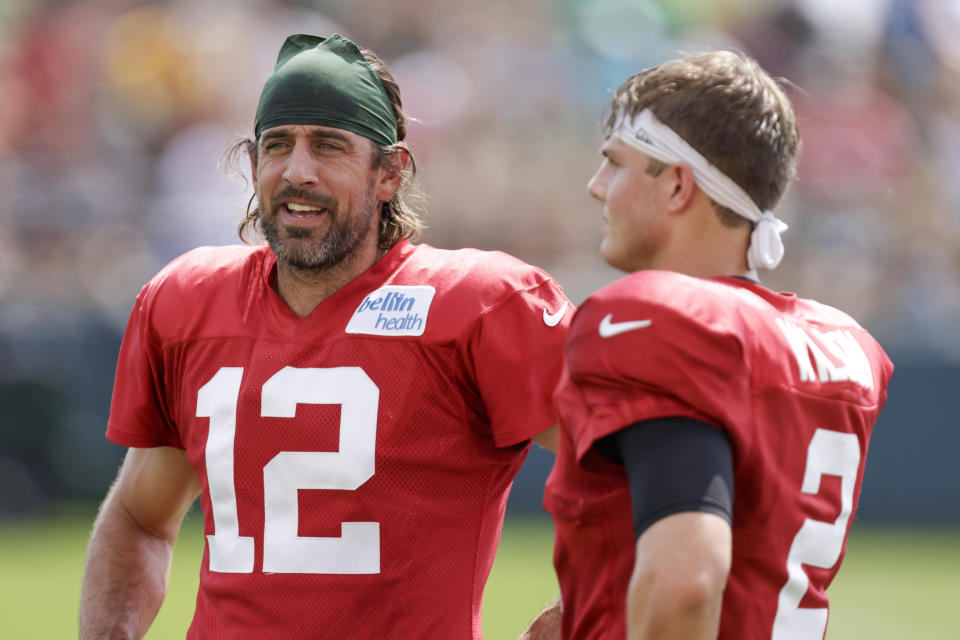 Green Bay Packers quarterback Aaron Rodgers (12) and New York Jets quarterback Zach Wilson (2) talk during a joint NFL football training camp practice Wednesday, Aug. 18, 2021, in Green Bay, Wis. (AP Photo/Matt Ludtke)