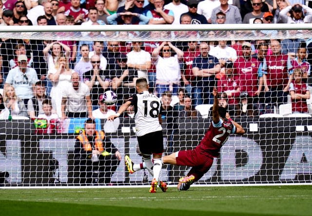 Andreas Pereira, left, scores Fulham’s first goal against West Ham