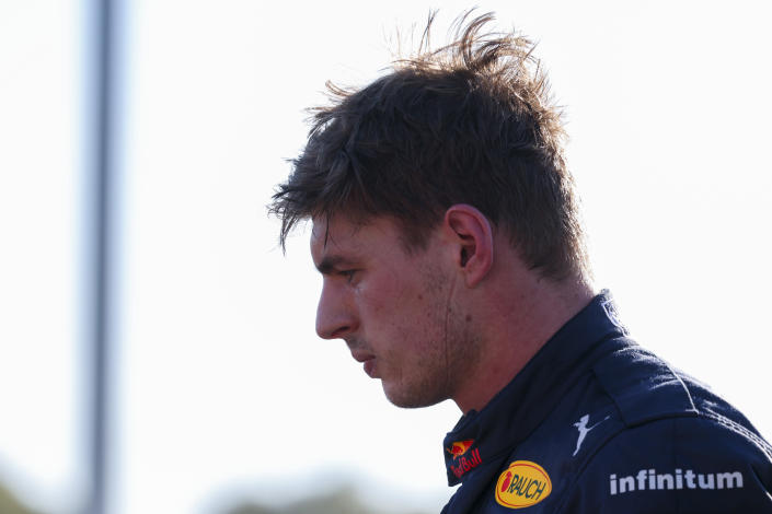 Red Bull driver Max Verstappen of the Netherlands looks at his car after he withdrew from the Australian Formula One Grand Prix in Melbourne, Australia, Sunday, April 10, 2022. (AP Photo/Asanka Brendon Ratnayake)