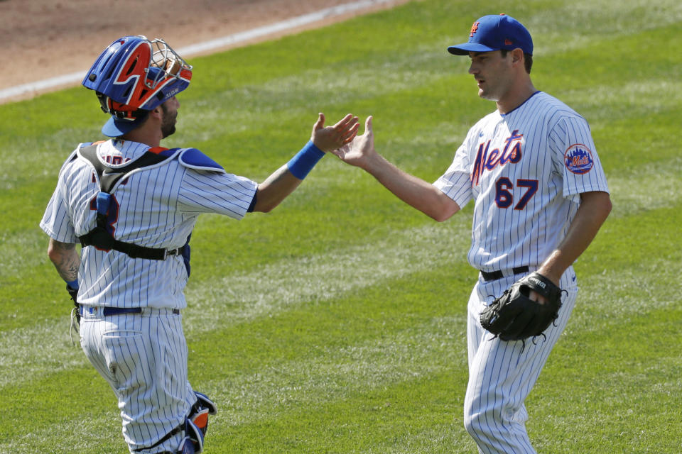 New York Mets catcher Tomás Nido (3) congratulates teammate Seth Lugo (67) after Lugo earned the save in the Mets victory over the Miami Marlins in a baseball game at Citi Field, Sunday, Aug. 9, 2020, in New York. (AP Photo/Kathy Willens)