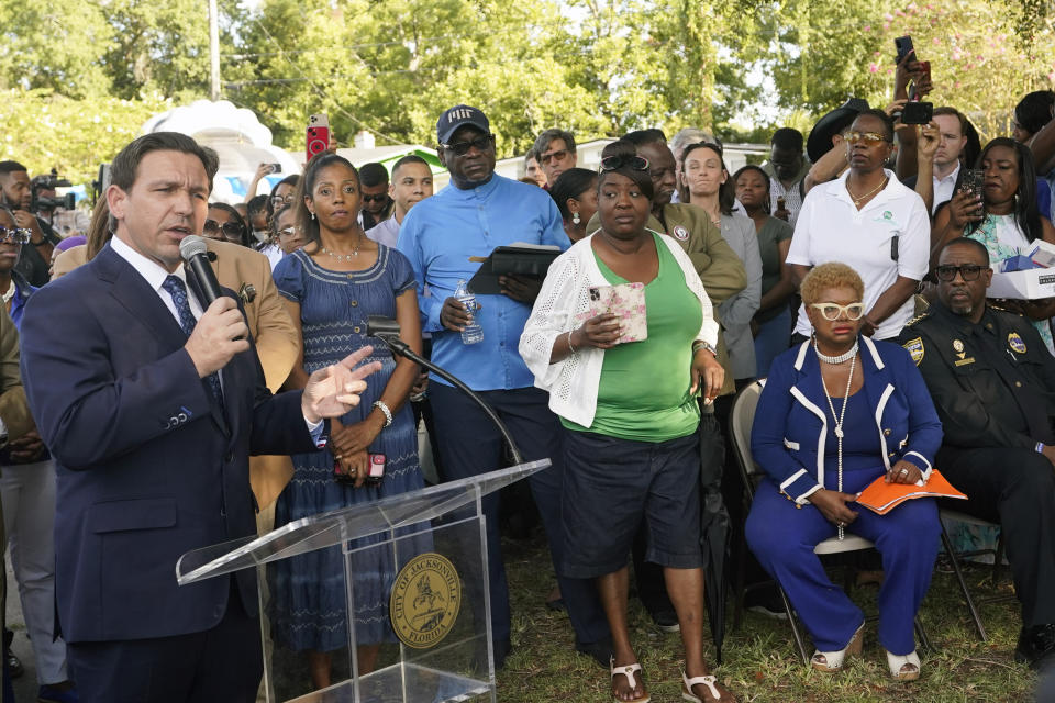 Florida Gov. Ron DeSantis, left, speaks at a prayer vigil for the victims of a mass shooting a day earlier, in Jacksonville, Fla., Sunday, Aug. 27, 2023. (AP Photo/John Raoux)