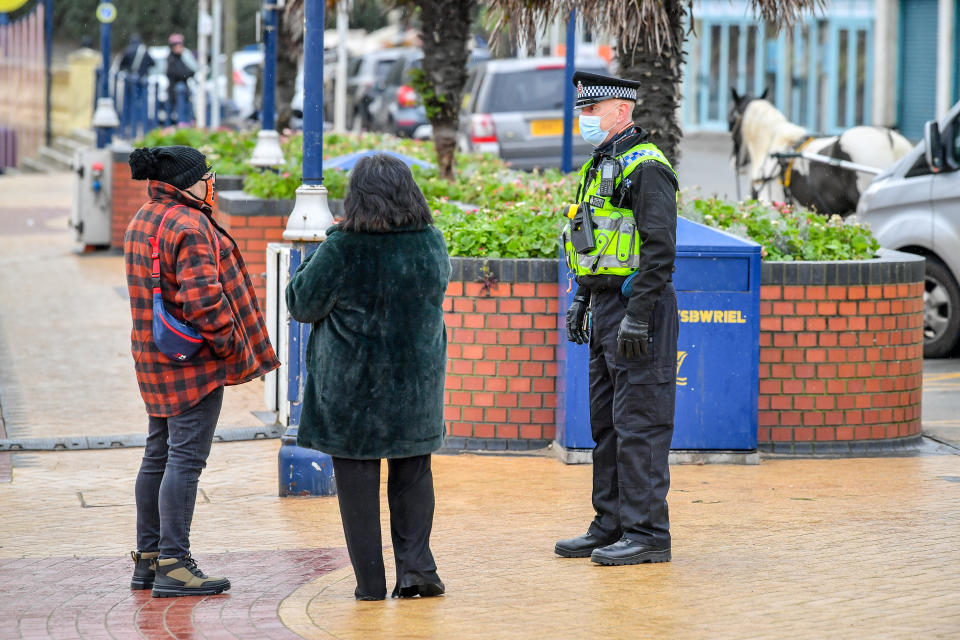 Police patrol Barry Island, Wales, which usually draws crowds for the New Year day swim, but is relatively empty as the country is in Level four of its coronavirus restrictions, the highest level available, due to the surge in coronavirus cases.