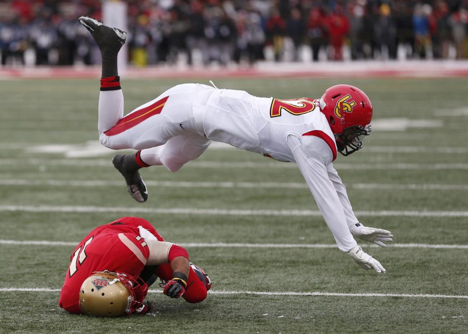 Calgary Dinos' Cuong Thai Lieu (R) dives over Laval Rouge et Or' Guillaume Rioux after an incomplete pass during the Vanier Cup University Championship football game in Quebec City, Quebec, November 23, 2013. REUTERS/Mathieu Belanger (CANADA - Tags: SPORT FOOTBALL)