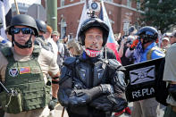 <p>White nationalists, neo-Nazis and members of the “alt-right” exchange insults with counter-protesters as they enter Lee Park during the “Unite the Right” rally August 12, 2017 in Charlottesville, Virginia. After clashes with anti-fascist protesters and police the rally was declared an unlawful gathering and people were forced out of Lee Park, where a statue of Confederate General Robert E. Lee is slated to be removed. (Photo: Chip Somodevilla/Getty Images) </p>