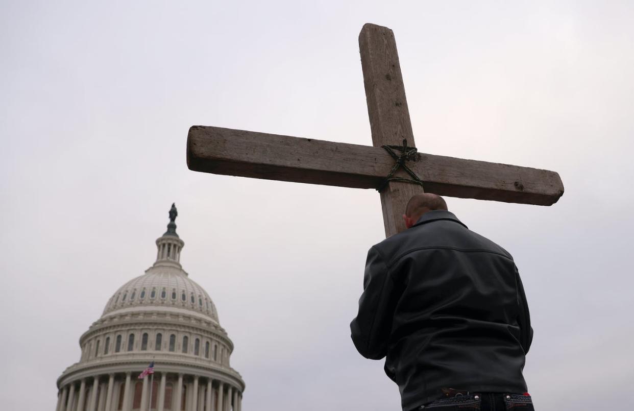 <span class="caption">Supporters of President Trump put up a Cross outside the U.S. Capitol on Jan. 6,</span> <span class="attribution"><a class="link " href="https://www.gettyimages.com/detail/news-photo/supporters-of-u-s-president-donald-trump-pray-outside-the-u-news-photo/1294872343?adppopup=true" rel="nofollow noopener" target="_blank" data-ylk="slk:Win McNamee/Getty Images;elm:context_link;itc:0;sec:content-canvas">Win McNamee/Getty Images</a></span>