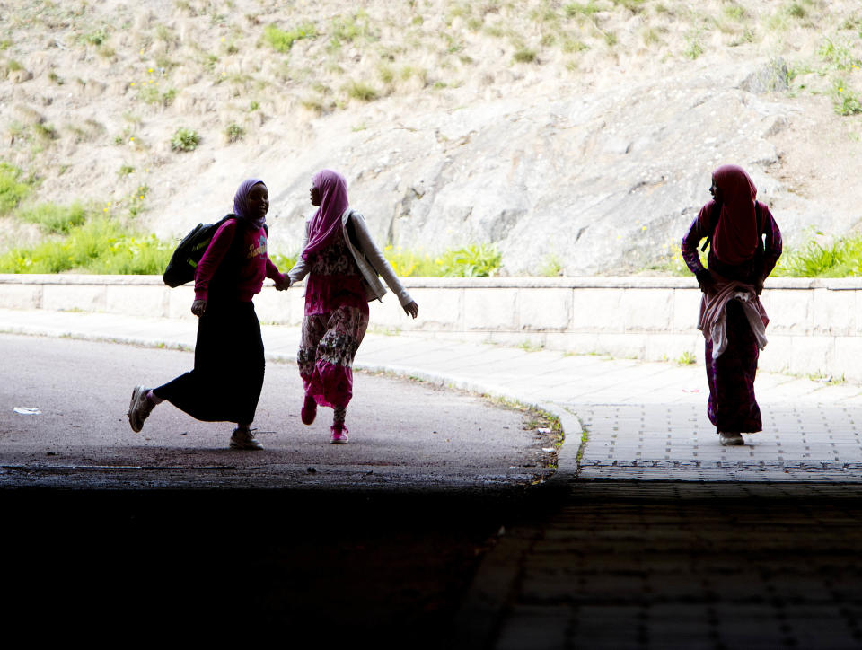 In this Aug. 30, 2018 photo migrant girls walk through a railway tunnel in Flen, some 100 km west of Stockholm, Sweden. The town has welcomed so many asylum seekers in recent years that they now make up about a fourth of the population. (AP Photo/Michael Probst)