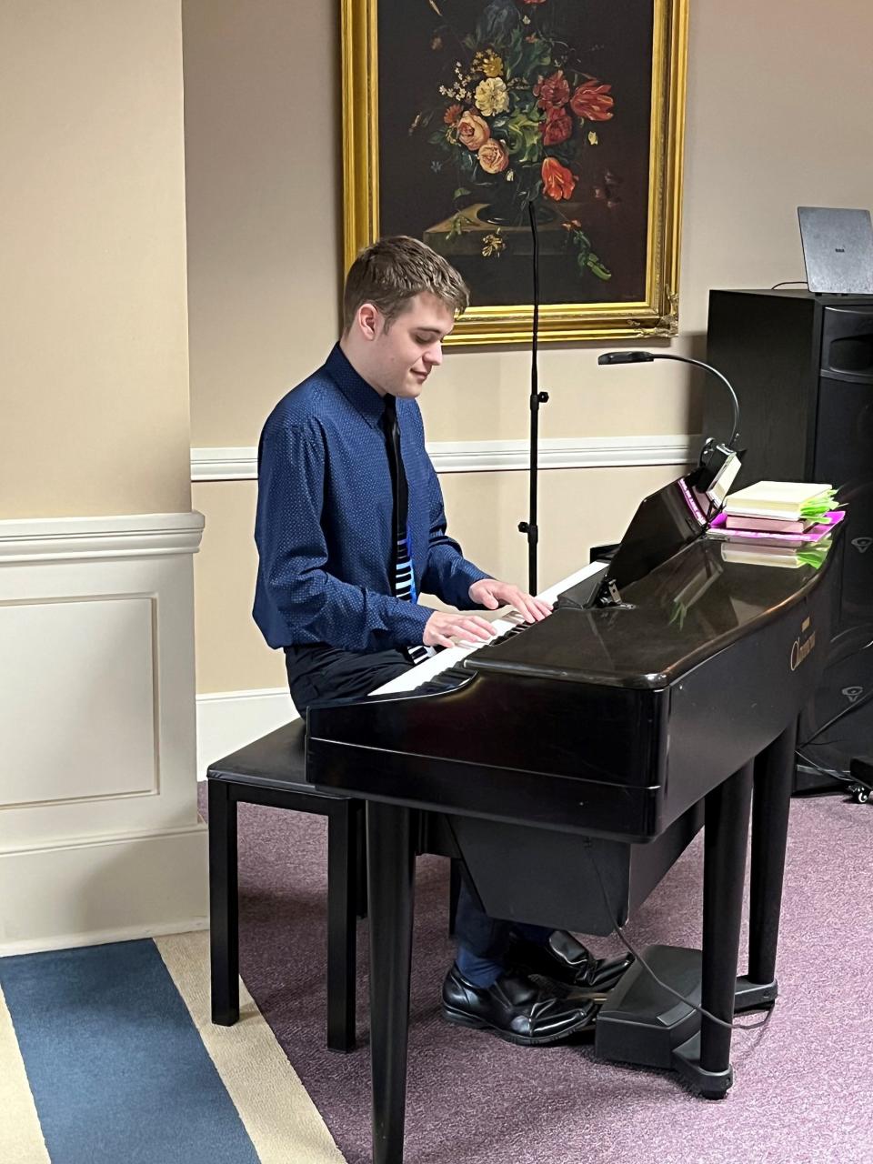 Ben Kredich of Knoxville plays piano at an assisted living home.