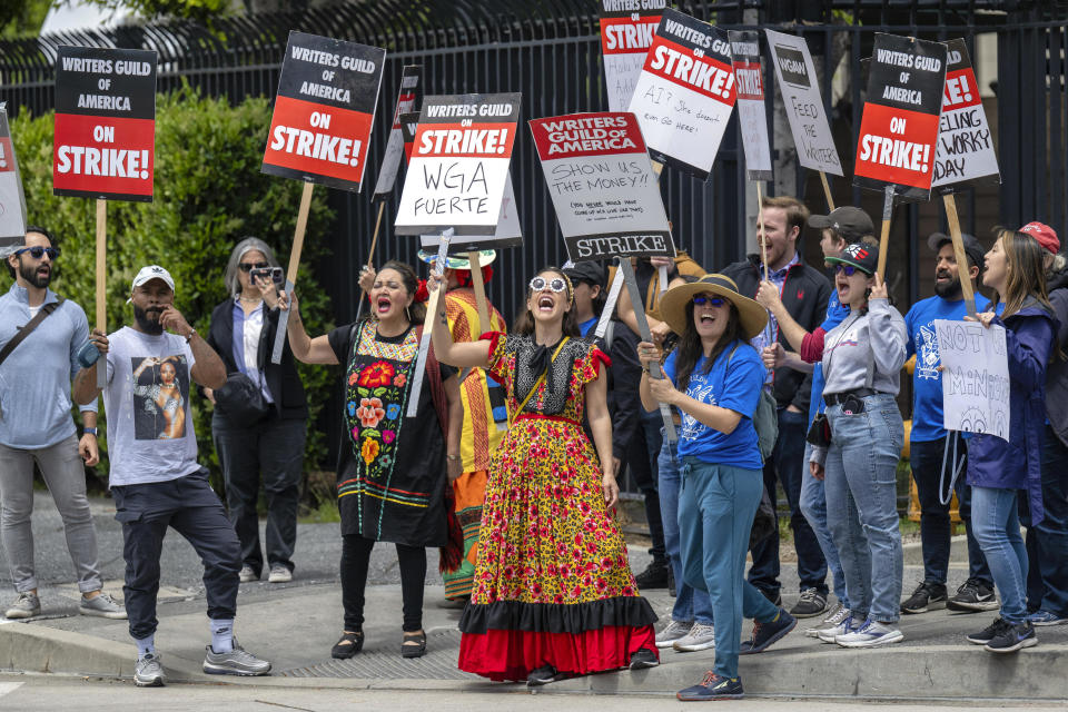 Demonstrators chant and hold signs during a Writers Guild of America demonstration outside of Universal Studios in Universal City, Calif., Friday, May 5, 2023. (Hans Gutknecht/The Orange County Register via AP)