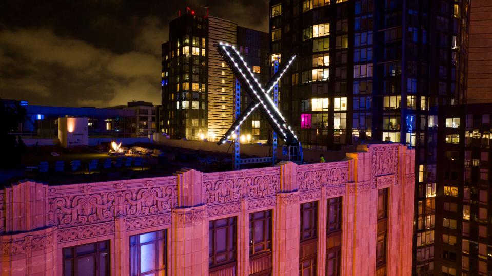 Workers install lighting on an "X" sign atop the company headquarters, formerly known as Twitter, in downtown San Francisco, on Friday, July 28, 2023. San Francisco has launched an investigation into the sign as city officials say replacing letters or symbols on buildings, or erecting a sign on top of one, requires a permit. (AP Photo/Noah Berger) ORG XMIT: CANB108