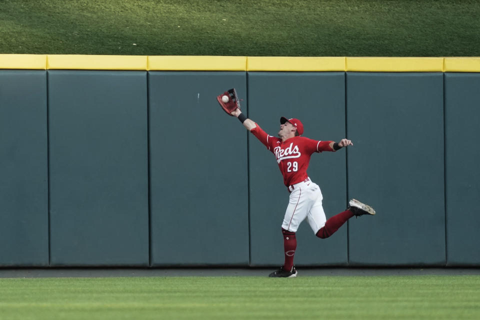 Cincinnati Reds center fielder TJ Friedl stretches to catch a fly ball hit by Chicago Cubs' Yan Gomes during the second inning of a baseball game Saturday, Sept. 2, 2023, in Cincinnati. (AP Photo/Joshua A. Bickel)