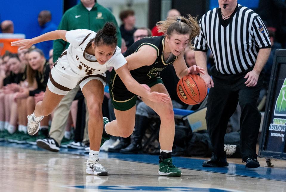 Archbishop Wood's Ava Renninger (4) recovers a loose basketball from Bethlehem Catholic's Aliyah Brame (14) during their PIAA Class 5A girls’ state semifinal basketball game in Norristown on Tuesday, March 19, 2024.