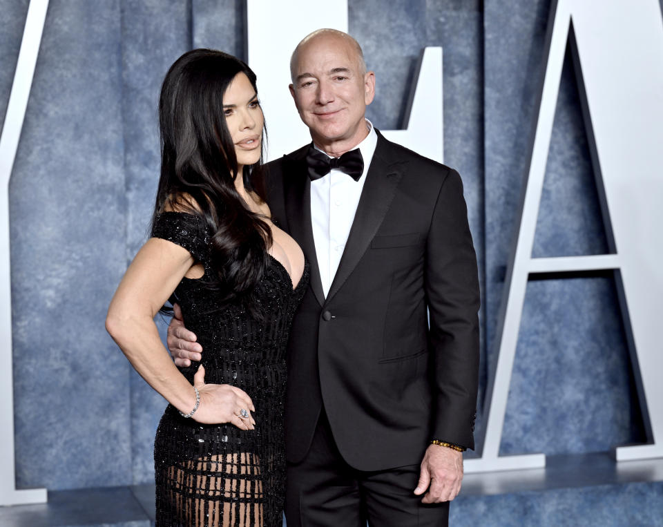 Lauren Sanchez, left, and Jeff Bezos arrive at the Vanity Fair Oscar Party on Sunday, March 12, 2023, at the Wallis Annenberg Center for the Performing Arts in Beverly Hills, Calif. (Photo by Evan Agostini/Invision/AP)