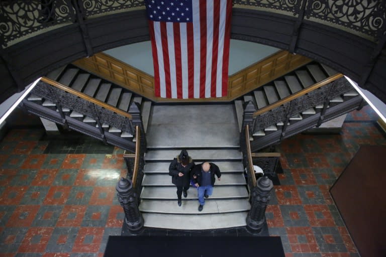 An Israeli-born woman (L) leaves after she received her US citizenship at a naturalization ceremony at the City Hall of Jersey City in New Jersey on February 22, 2017