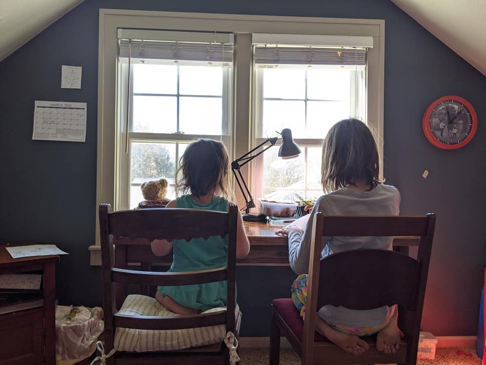 The Roys in their attic "classroom" in 2020, participating in COVID lockdown schooling.