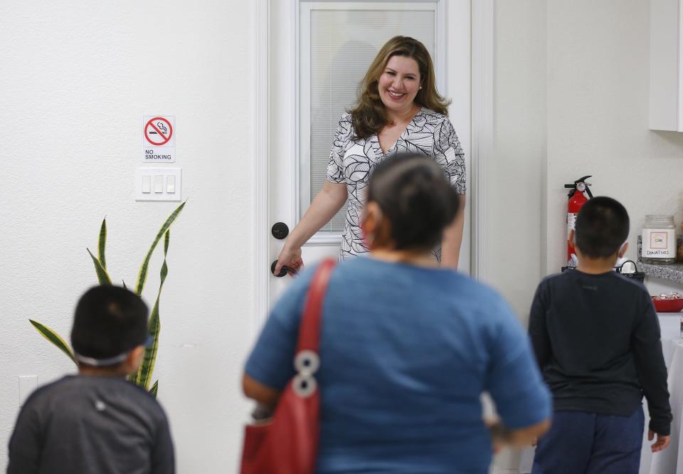 Gabby Orozco greets children in her office in Phoenix.