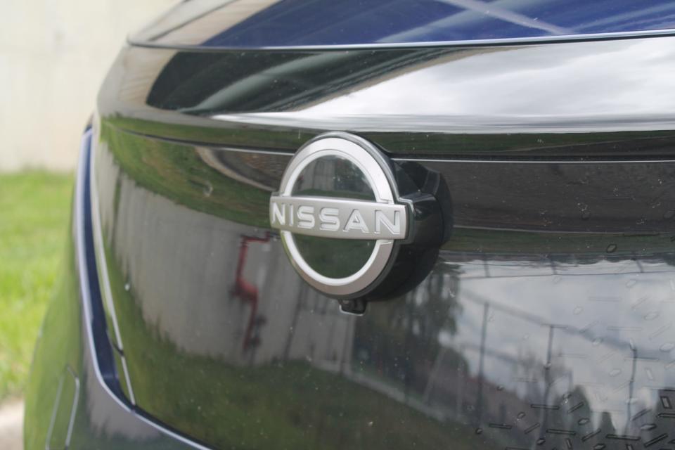 The Nissan logo on the nose of the 2023 Nissan Ariya.