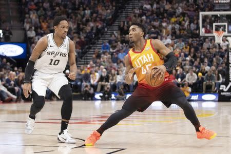 Feb 9, 2019; Salt Lake City, UT, USA; Utah Jazz guard Donovan Mitchell (45) steps back to shoot the ball while defended by San Antonio Spurs guard DeMar DeRozan (10) during the second quarter at Vivint Smart Home Arena. Mandatory Credit: Rob Gray-USA TODAY Sports