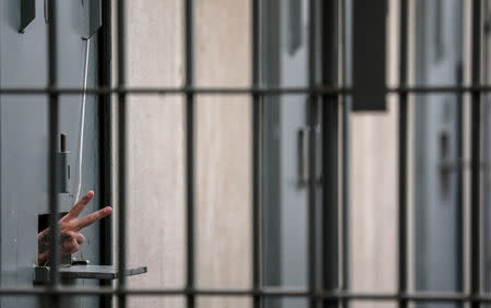 An inmate gestures at the state penitentiary in Canoas, Brazil August 30, 2018. REUTERS/Diego Vara/File Photo