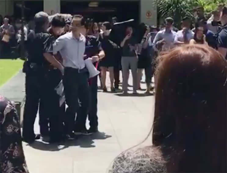 Protestor who called for the resignation of Prime Minister Lee Hsien Loong outside Raffles Place MRT was charged on Wednesday (5 July). Photo: Facebook video