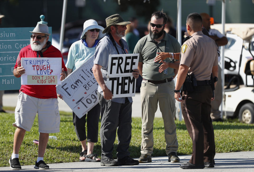 Police talk with demonstrators outside the Homestead Temporary Shelter for Unaccompanied Children, Tuesday, Feb. 19, 2019, in Homestead, Fla. (AP Photo/Wilfredo Lee)