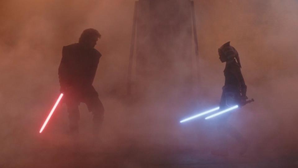 Anakin and his red lightsaber fighting with young Ahsoka and her two white ones in a smoky mist