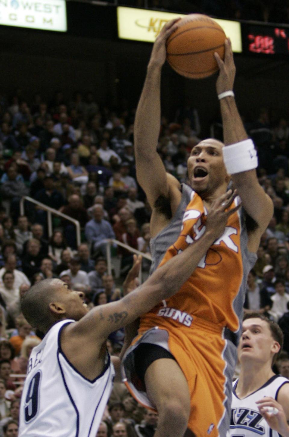 Phoenix Suns forward Shawn Marion (31) is fouled by Utah Jazz guard Raja Bell (19) during the second quarter Wednesday, Jan. 12, 2004, in Salt Lake City.