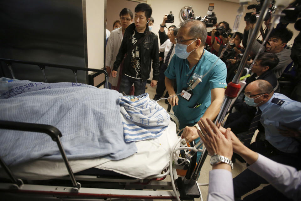 <p> Medical staffs escort former Ming Pao chief editor Kevin Lau on a stretcher in a hospital in Hong Kong, China Wednesday, Feb. 26, 2014. The former editor of the Hong Kong newspaper whose abrupt dismissal in January sparked protests over press freedom has been stabbed, police said on Wednesday. Police said a man wearing a motorcycle helmet “suddenly” attacked Kevin Lau on Wednesday morning with a knife and then fled on a motorcycle driven by another man. (AP Photo) </p>