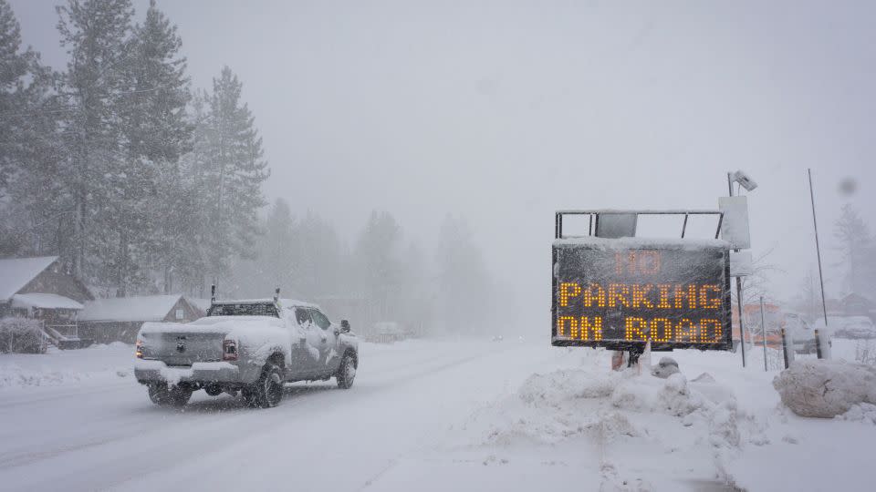 A sign warns motorists of parking restrictions as snow falls Friday in Truckee, California. - Brooke Hess-Homeier/AP